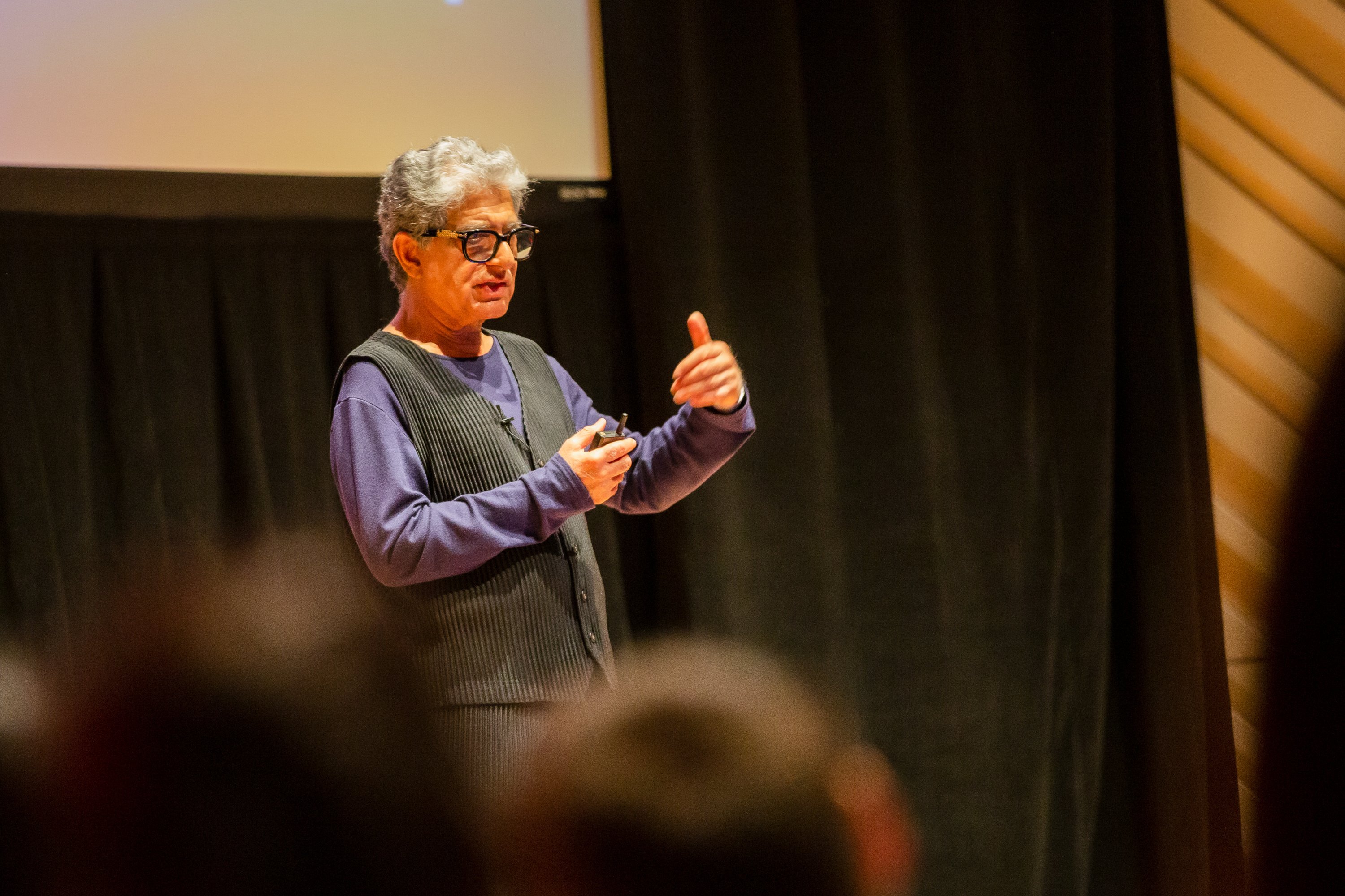 iin chief wellness officer deepak chopra speaks to an audience